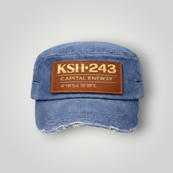 K&ChildrenBusiness distressed blue denim military cap with brown leather patch featuring gold text.