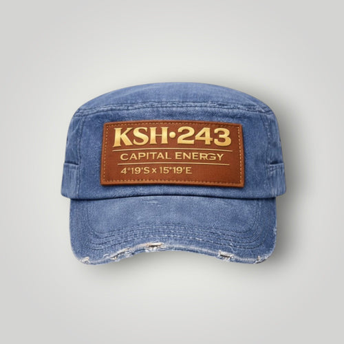 K&ChildrenBusiness distressed blue denim military cap with brown leather patch featuring gold text.